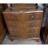 A 28" reproduction mahogany serpentine front chest of four long drawers, set on bracket feet - for