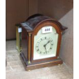 A mahogany cased dome topped mantel timepiece with flanking pillars and back winding movement - sold