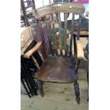 An antique high lath back elbow chair with moulded solid elm seat, set on turned legs - age