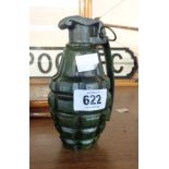 A modern reproduction cast iron money box in the form of a hand grenade