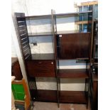 A 4' 1" vintage Staples Ladderax stained mixed wood wall unit with six shelves, three uprights, twin