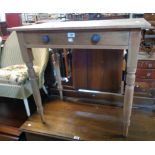 A 30" old stripped pine side table with long frieze drawer, set on turned legs - old wear and worm