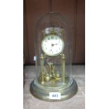 A 20th Century brass anniversary clock under later perspex dome - tarnished