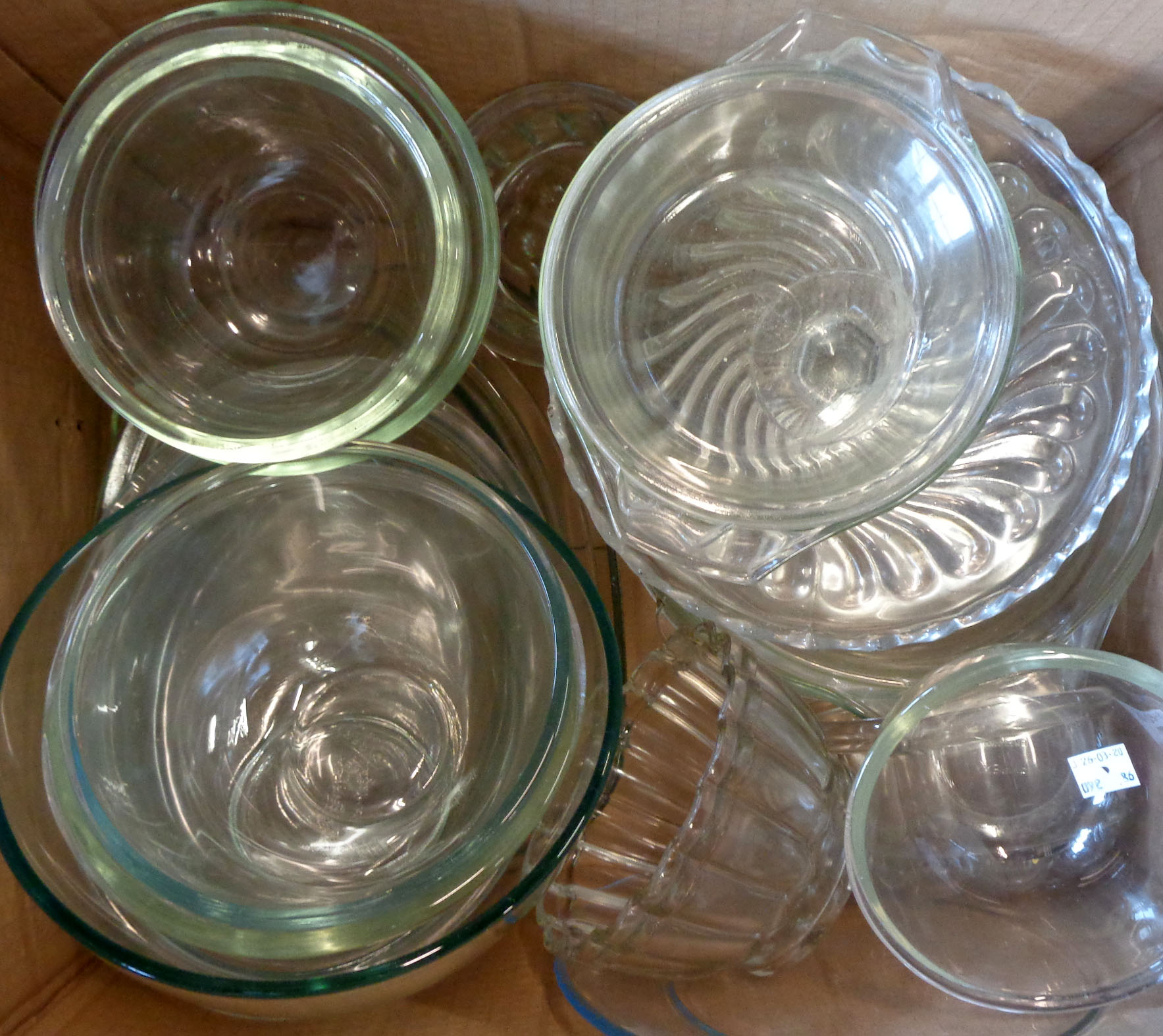 A box containing assorted glass kitchenware including jelly moulds, Pyrex, etc.