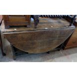 A 4' 5" antique solid oak gateleg dining table, set on bobbin turned supports - end drawer missing