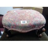 A Victorian mahogany footstool with remains of upholstered top, set on scroll cabriole legs