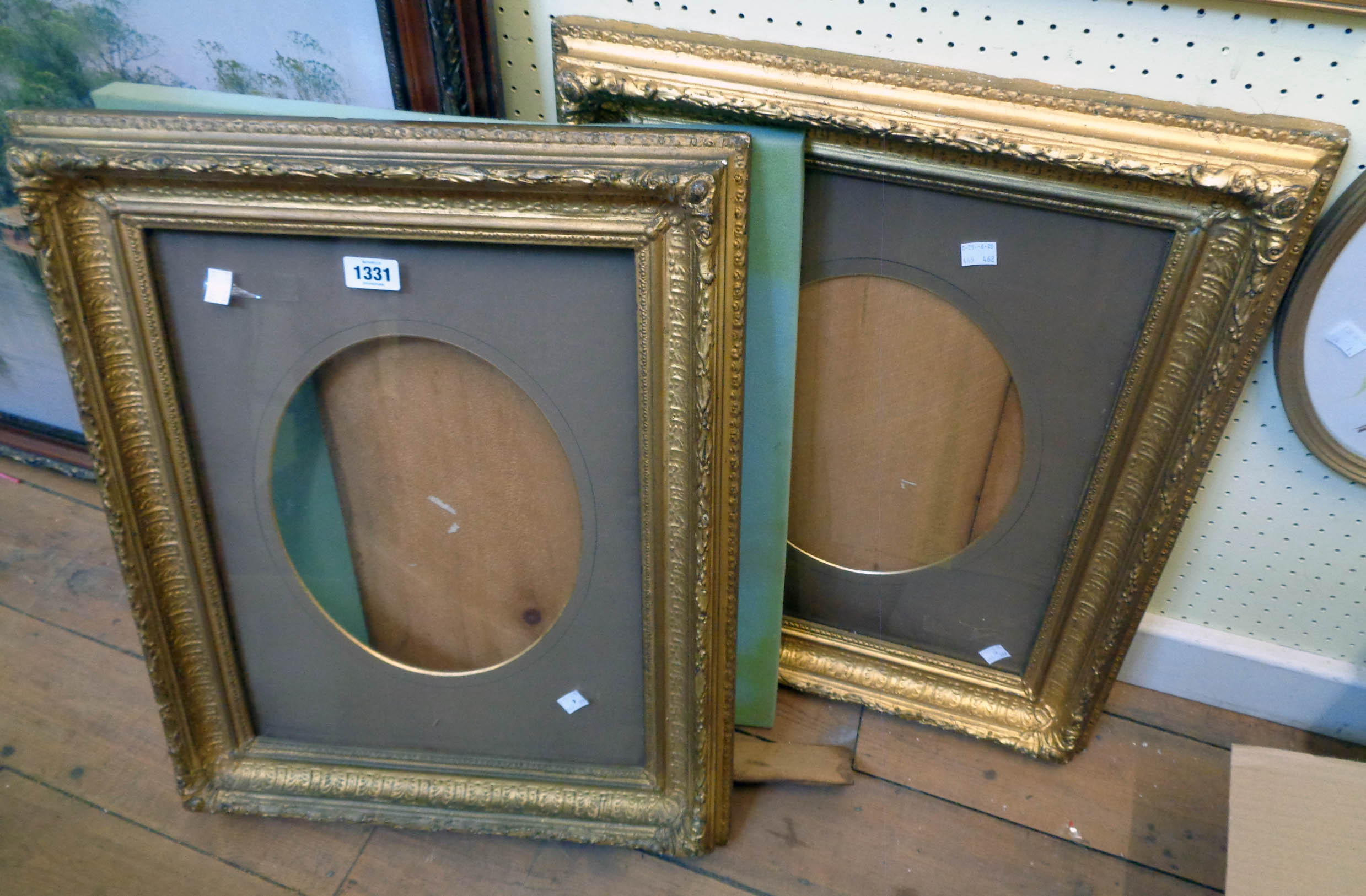 A pair of 19th Century gilt gesso picture frames with glass and oval mounts - full size of