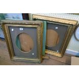 A pair of 19th Century gilt gesso picture frames with glass and oval mounts - full size of