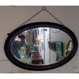 An early 20th Century grained and beaded framed bevelled oval wall mirror