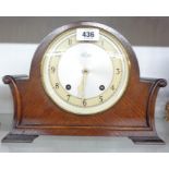 A vintage Garrard polished oak cased mantel clock with scroll sides and eight day gong striking