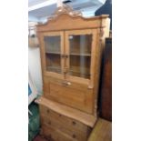 A 3' 3" continental pitch pine secretaire chest with pierced pediment, flanking applied