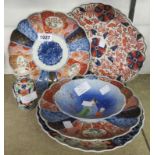 A pair of Imari plates, figural dish, a small vase and two further Imari plates - some minor damage