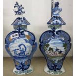 Two similar 19th Century Dutch Delft vases and covers, one with central panel depicting a lady