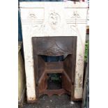 An Art Nouveau painted cast iron bedroom fireplace insert