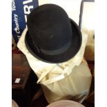 A Garrett & Haigh top hat, another and a black bowler - various condition