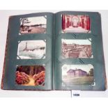 An early 20th Century leather bound album containing a collection of postcards including numerous