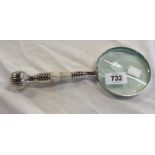 A magnifier with mother-of-pearl and silver plated handle