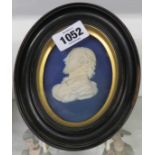 A 19th Century Wedgwood oval dark blue Jasper dip plaque depicting Shakespeare in ebonised wood