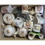 A quantity of assorted ceramics including commemorative mugs, decorative teapots, etc.