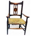 An early 20th Century stained beech framed child's elbow chair, marquetry panel to splat depicting