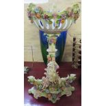 A 20th Century porcelain centre piece decorated with cherubs and applied flowers