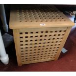 A modern hardwood laundry basket of lattice design