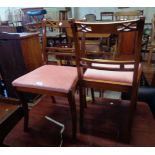A set of four reproduction mahogany framed Regency style dining chairs with old rose velour