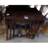 A nest of three 20th Century stained oak tea tables