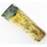 An antique carved bone chisel emblazoned with Masonic symbols including coffin, pentagram, ladder to