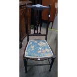 An Art Nouveau inlaid walnut framed bedroom chair with upholstered seat panel