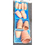 A quantity of terracotta plant pots