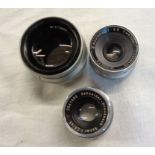 Three vintage enlarger lenses including Minolta