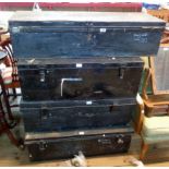Two black painted tin transit trunks and two footlockers similar