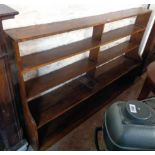 A 6' 20th Century polished oak four shelf open waterfall bookcase with shaped sides - minor wear