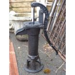 A reproduction painted cast iron garden pump