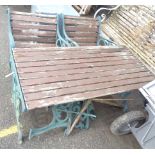 A cast iron garden suite with table, bench and two chairs - various condition