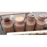 Four old milk churns