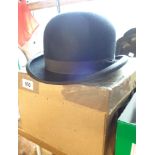 A boxed G.A. Dunn & Co. grey top hat with pair of Veloura gloves - sold with a Gieves black bowler