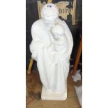 A hollow plaster religious statue of a man with child - base chipped