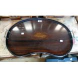 A 24" Edwardian inlaid mahogany kidney shaped tea tray with central shell motif and flanking brass
