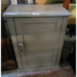 A 16 1/2" old pine cabinet with later grey painted finish and panelled door