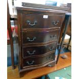 A 19 1/4" reproduction mahogany serpentine front chest of four long drawers, set on bracket feet -