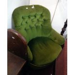 A late Victorian boudoir tub chair upholstered in green button back velour, set on turned front legs