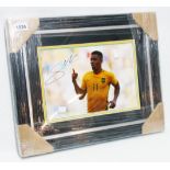 Gabriel Jesus: a framed coloured photograph in Brazil strip signed by the player and with