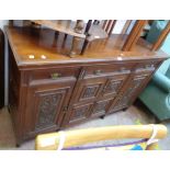 A 5' Edwardian walnut sideboard base with three frieze drawers and carved panel decoration to