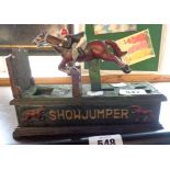 A reproduction cast iron show jumper money box