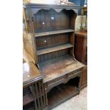 A 33" 20th Century Archer & Smith stained oak potboard dresser with two shelf open plate rack over a