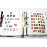 Two ring bound folders containing a collection of Victorian and later hinge mounted World stamps