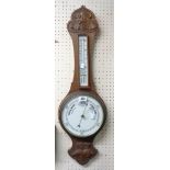A carved oak cased banjo barometer/thermometer with printed ceramic dial and scale - repair