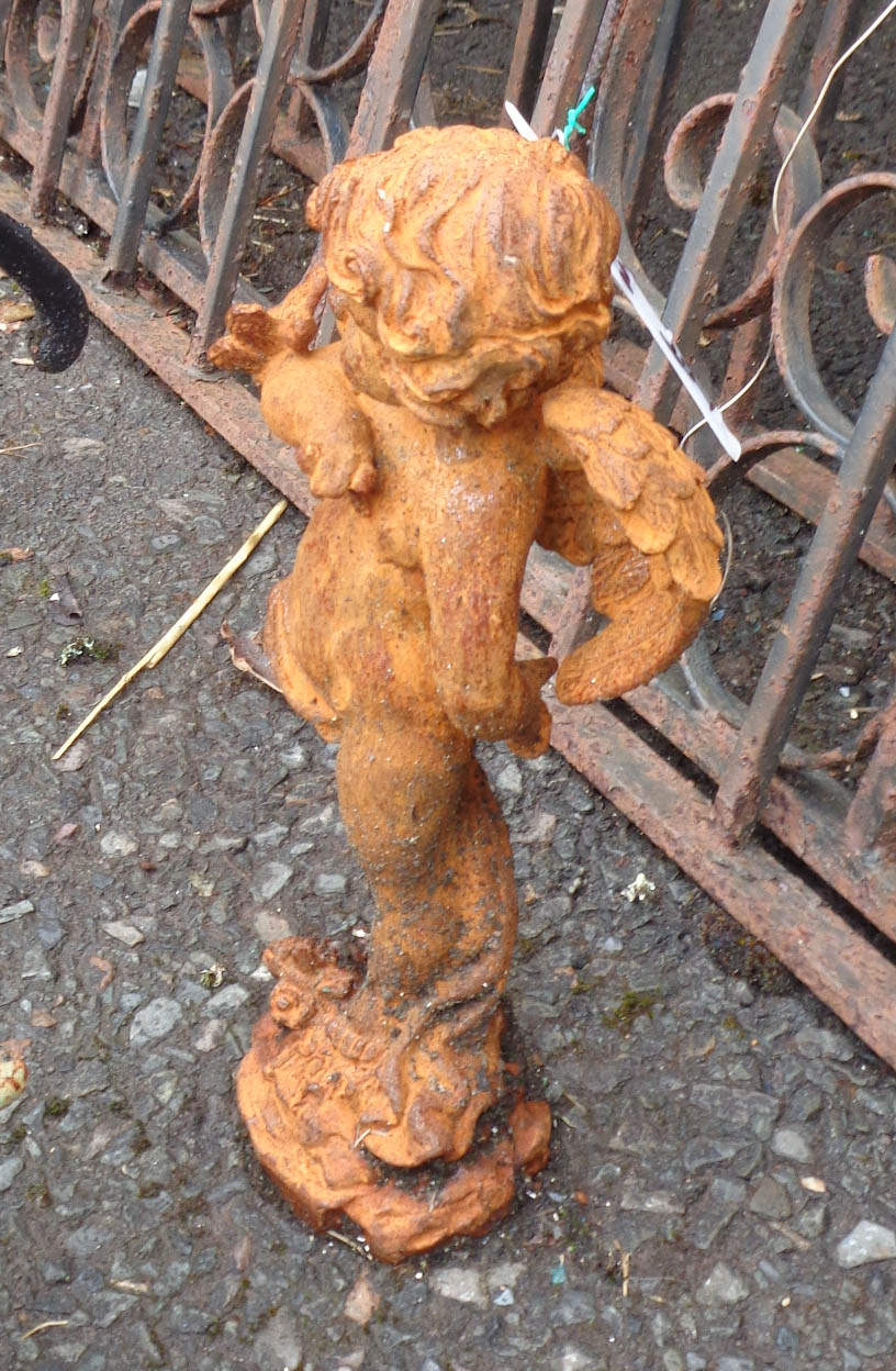 A small cast iron cherub with butterfly